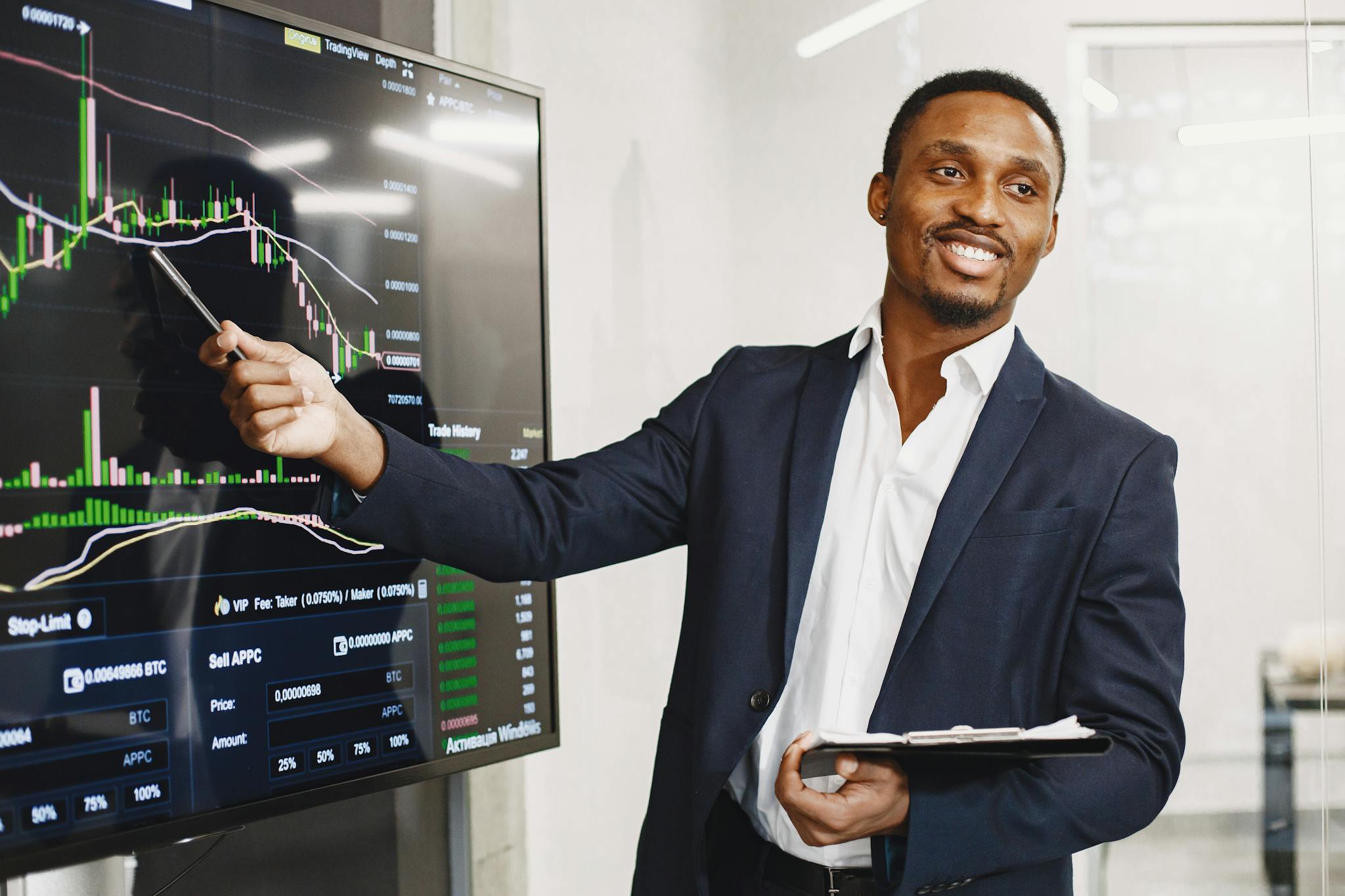 Photo by Gustavo Fring Businessman presents financial data using graphs, showcasing technology and analysis in a corporate environment.